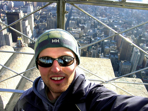 A self-portrait from the observatory of the Empire State Building. The camera is above me in my beanie and sunglasses with midtown Manhattan acting as a backdrop