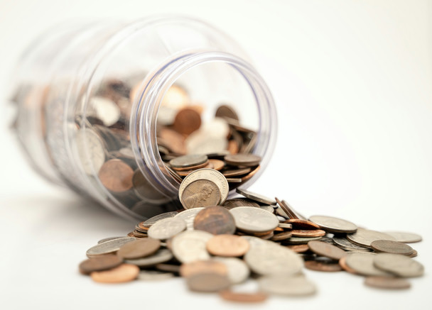 Coins falling out of a glass jar