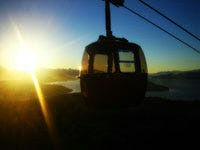 As the sun sets over Lake Llao Llao, a téléphérique carriage passes us as we head down to ground level in our carriage